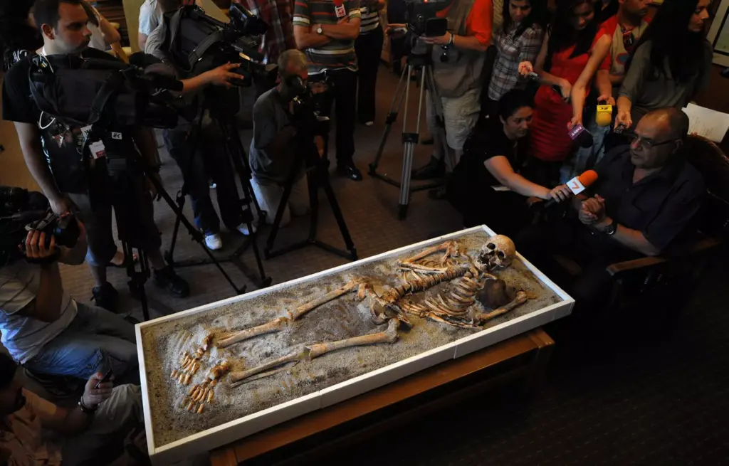 Bizhidar Dimitrov R head of National History museum speaks to journalists next to a skeleton with an iron piece at the National History museum in Sofia